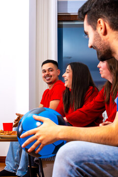 Football fans watching match together at home, celebrating goal and championship