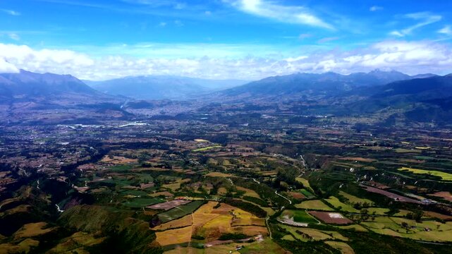 Aerial View of Andean Agricultural Valley in Ecuador, Patchwork Farmland, Mountain Ranges, Rural Settlements and Scenic Highland Travel Landscape