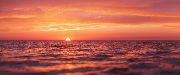Fototapeta premium Tranquil seaside view illuminated by fiery sunset offering copy space