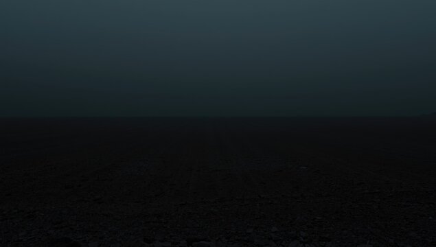 Muted dark backdrop displaying deserted parched land with copy space