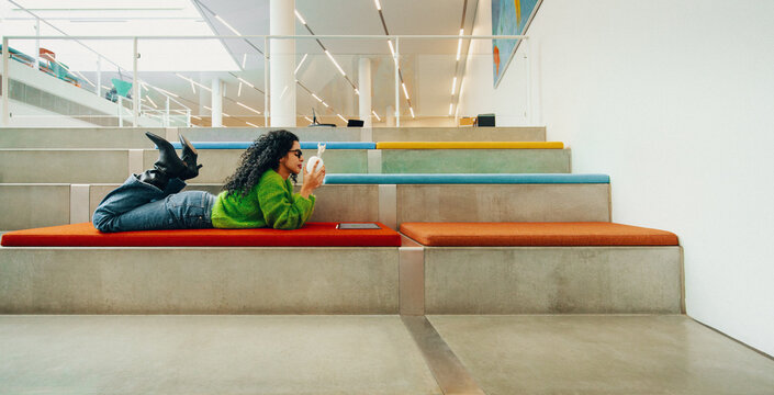 Woman using tablet on indoor steps for study and education