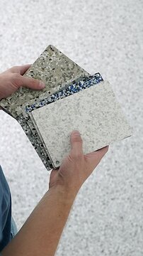 Interior designer choosing terrazzo vinyl flooring swatches for renovation
