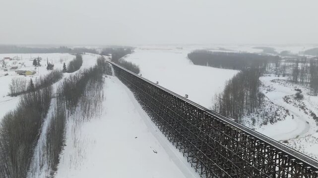 High Angle Perspective of a Long Train Trestle Bridge Covered in Snow