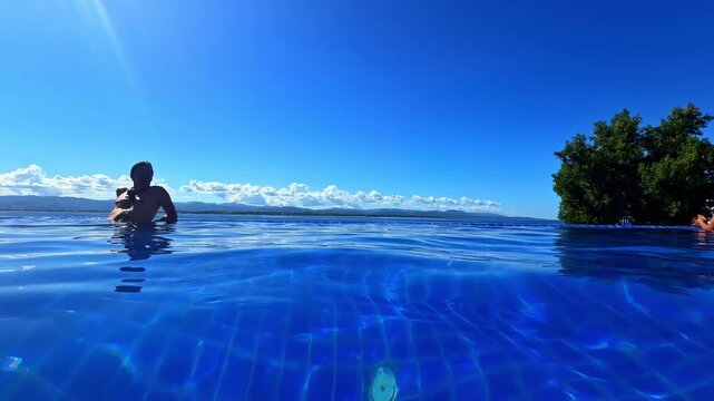 A Man In A Pool At Dusit Thani Mactan Cebu On The Punta Enga&ntilde;o Peninsula In Lapu-Lapu City, Philippines. Static Shot