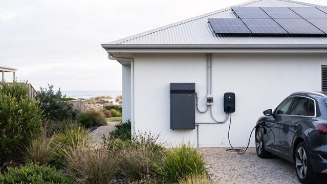 Residential Battery System Beside Coastal Home, Rooftop Solar, Electric Vehicle Charging, Household Energy Independence and Backup Power