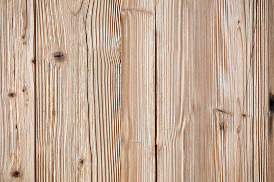 Textured view of wooden wall and floor surface composed of vertical planks. Highly detailed texture of softwood with prominent grain pattern. Planks vary in width hinting at a rustic or aged aesthetic