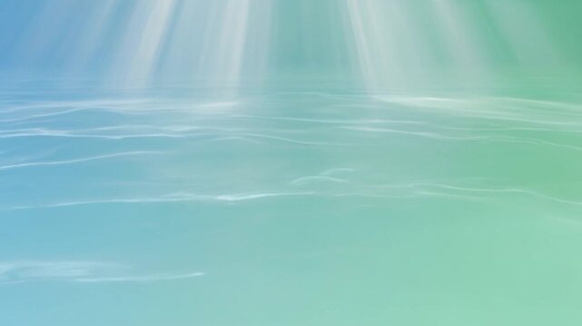 Sunlight rays shining through blue tropical water surface