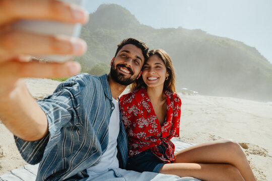 The moment we saved: A couple taking a selfie on the sand