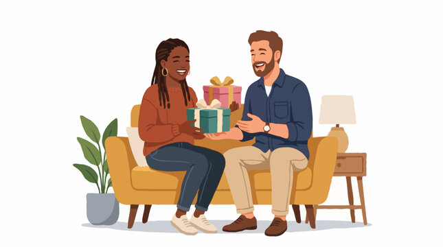 A man gives a gift to a woman while sitting on a sofa. The woman is smiling and holding the gift