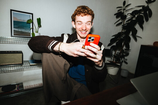 The phone becomes part of his work routine in a relaxed home office.