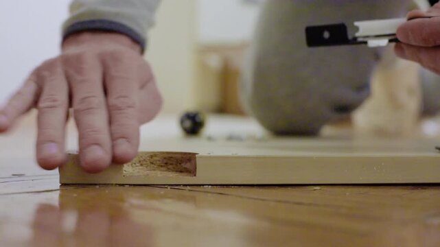 Caucasian worker secures roller mount and verifies position carefully. Technician from Caucasian background finishes mounting and confirms precise flush alignment thoroughly