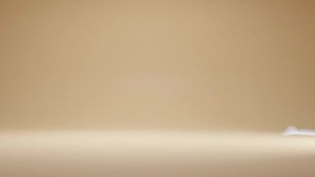 abstract subtle white smoke flowing and swirling gently on a beige background studio portrait