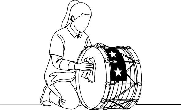 Young girl playing a large bass drum with stars.