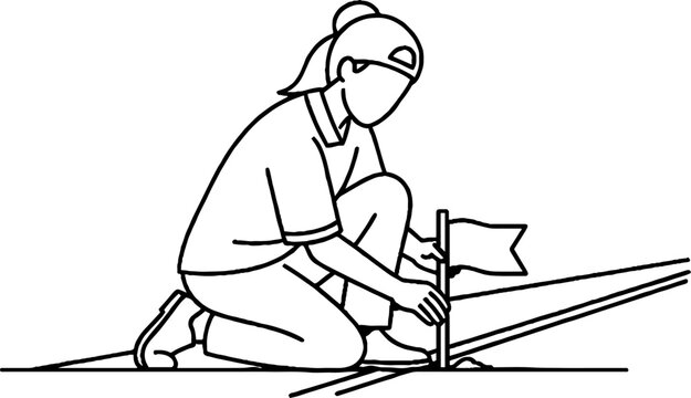 Person planting small flag on sloped ground outdoors.
