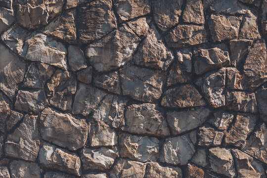 Natural stone wall showcases a beautiful array of textures and colors, inviting a sense of rugged elegance to any surroundings