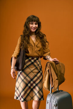 Stylish young woman ready for summer adventures with trendy attire and travel accessories