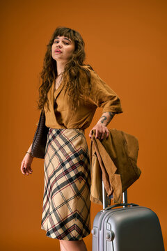 Young beautiful woman stylishly prepared for exciting summer adventures