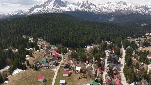 Aerial View of Zabljak Town and Snow Capped Peaks of Durmitor Mountain, Montenegro, Drone Shot
