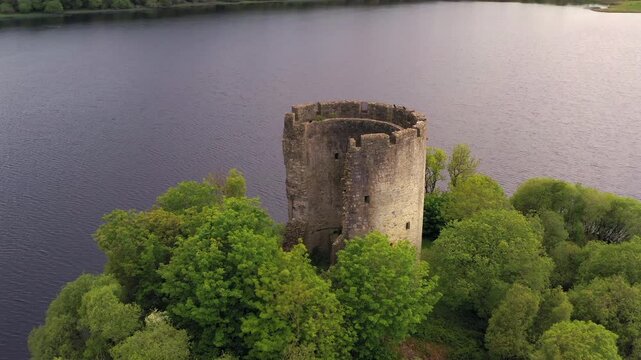 Dynamic aerial shot of historic Cloughoughter Castle on quiet evening, County Cavan Ireland