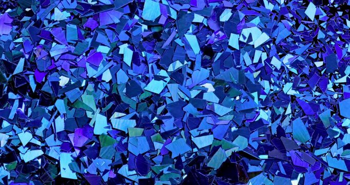 Iridescent holographic flakes slow rotation. Close-up of dense multicolored shiny fragments with vibrant blue, cyan, orange and gold reflections. 