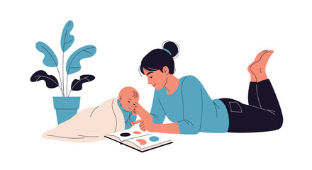 Obraz premium Young mother lying on the floor and showing a colorful picture book to her baby near a houseplant during a cozy and educational home activity.