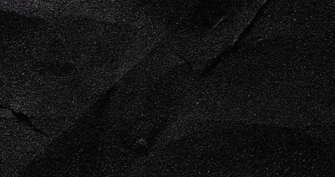  Dark cracked texture slow rotation. Close-up of deep black surface with intricate white vein patterns and natural cracks. Smooth continuous rotation reveals evolving light reflections.