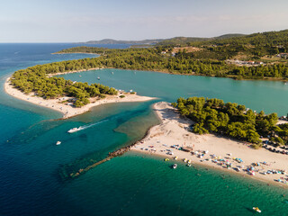 Obraz premium Port Glarokavos beach and sea, Kassandra Halkidiki, Greece. Amazing sea with clear blue water. Aerial panoramic drone view from above, top view from drone. Summer holidays Europe