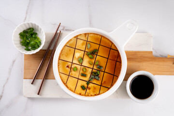 Viral steamed egg custard, silky Asian egg Pan-Steamed Omelette with Sesame Oil, Soy Sauce, and Scallion. Chinese zheng dan or Korean gyeran jjim traditional recipe © ricka_kinamoto