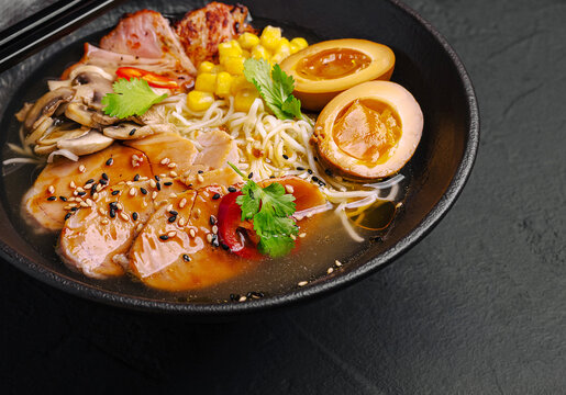 Ramen bowl with pork, noodles, corn, mushrooms, and soy eggs