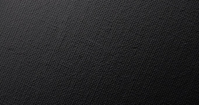 Dark teal fabric surface with tight fine weave pattern. Smooth continuous rotation reveals subtle shifts in light and shadow across the textile texture, perfect for backgrounds.