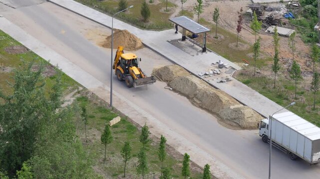 Aerial view of road maintenance works with construction machinery preparing damaged pavement for resurfacing and infrastructure improvement