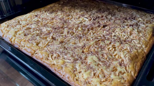 Apple charlotte on a baking sheet in the oven