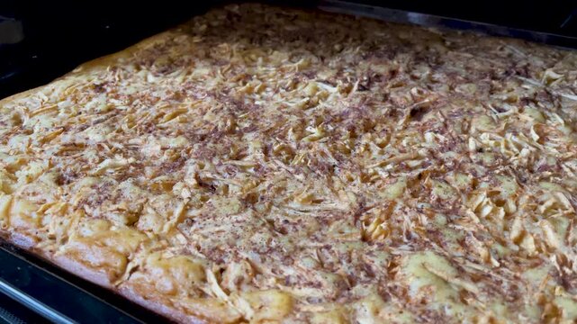 Apple charlotte on a baking sheet in the oven