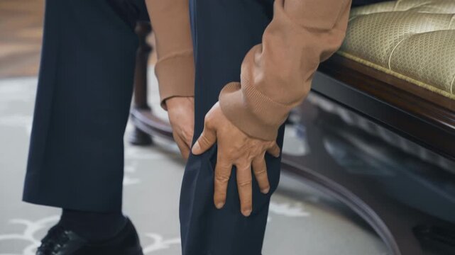 Elder mature man hands massaging leg calf muscle cramps, trauma from inflammation of tendon at calves, grandfather suffers from painful severe knee joint pain, could not walk, illness, cramps