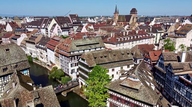Pont Faisan and Place Benjamin Zix with Saint-Pierre-le-Vieux church in background, Petite France district in Strasbourg, France. Aerial forward