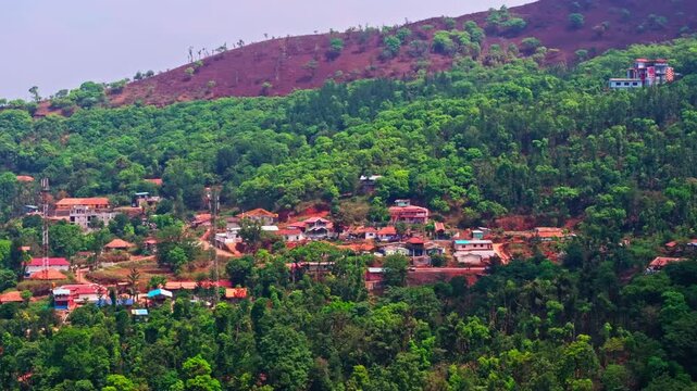 Close up shot of Mountain Village with mobile signal towers, lush greenery and hill top at attigundi village, Dattatreya Peeta, Chikmagalur, Karnataka, india. day time, trucking shot, drone shot, 4k.
