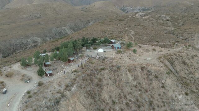 Aerial view of the Observatorio Astronomico Ampimpa complex surrounded by remote mountain landscapes in Tucum&aacute;n, Argentina.