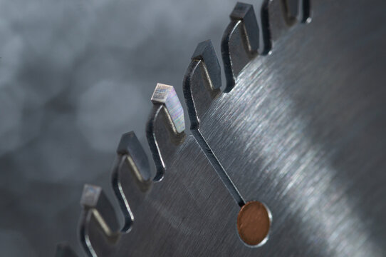 Macro close-up of a professional TCT circular saw blade with sharp carbide teeth.