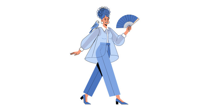 Elegant woman in blue suit holding a fan walking confidently.
