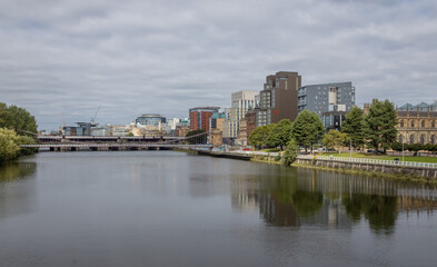 Fototapeta premium River Clyde waterfront and modern skyline in Glasgow, Scotland. View of the River Clyde and modern riverside developments in Glasgow, Scotland, featuring contemporary architecture, urban regeneration,