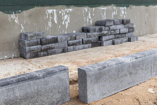 Brick paving.  laying the curb of a paved path. work on laying stone bricks on a path