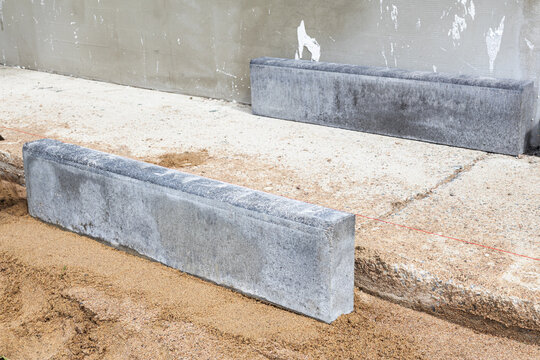 Brick paving.  laying the curb of a paved path. work on laying stone bricks on a path