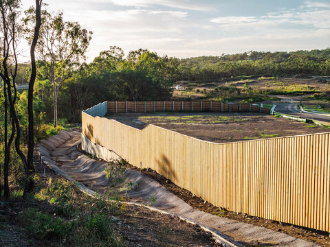 Wooden fence next to drainage and unfinished residential development