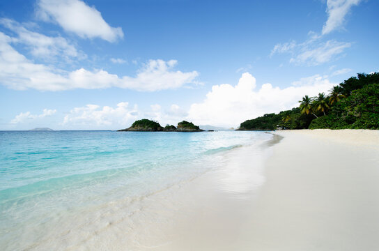 Cal sea waves washing empty Trunk Bay beach