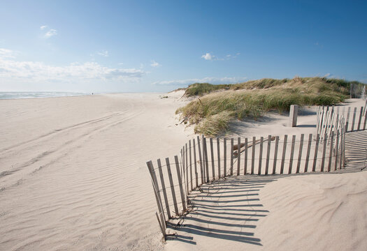 Fence on empty Madaket Beach on sunny day