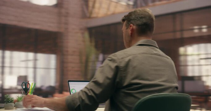 360 Degree. Businessman Using Laptop Computer While Working in Modern Office, Reviewing Printed Documents With Data Charts at Desk. Orbital Cinematic Arc Tracking Pan Camera Movement Shot