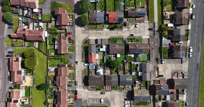 Vertical aerial view directly above a Sunderland residential neighbourhood showing suburban housing streets gardens parked vehicles solar panels and urban planning patterns captured from a drone