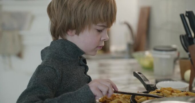 Kid Boy Put Fried Potato in Dish. Eating Breakfast Lunch in Kitchen. 4K 10-bit
