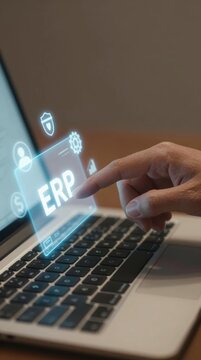 Person using a laptop to access ERP software features and tools