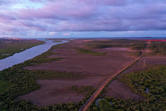 Sunset aerial view of coastal wetland estuary